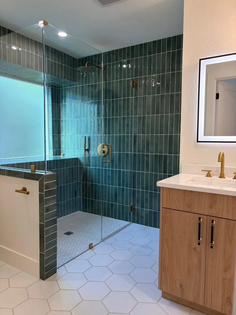 Updated bathroom with glass shower, tiled walls and a new vanity